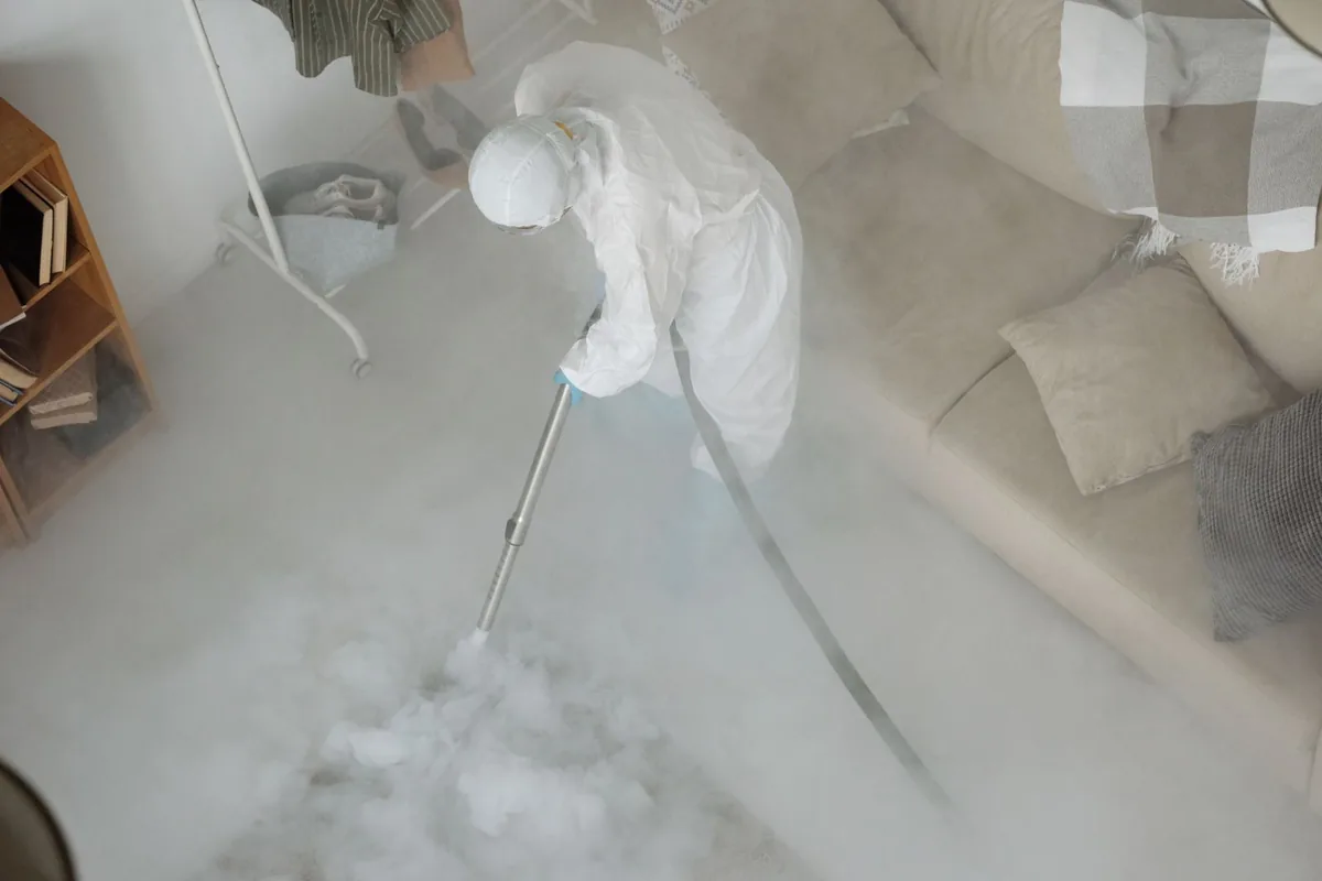 Biohazard cleanup technician in protective equipment, Coppell, TX